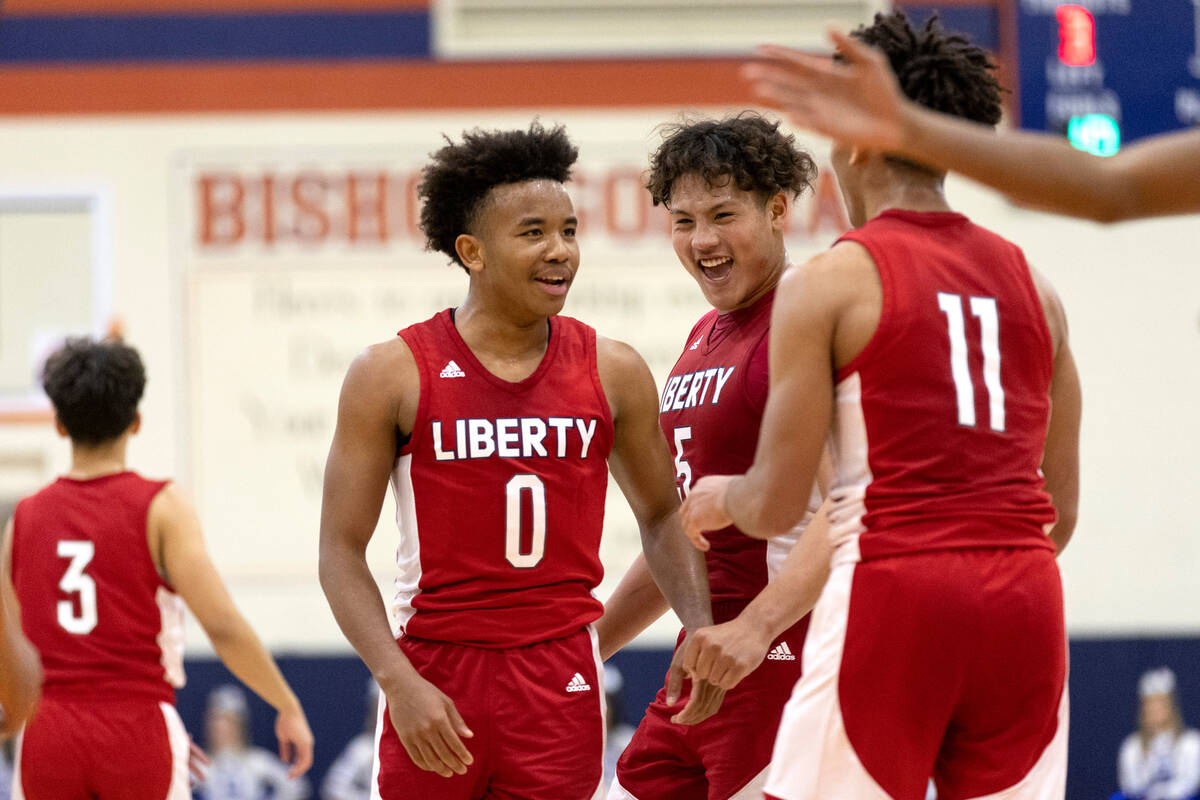 Liberty’s Tyus Thomas (0), Andre Porter (5) and Dedan Thomas Jr. celebrate a foul called on B ...