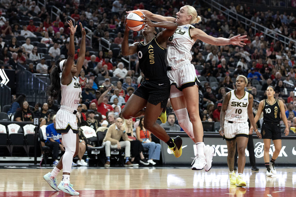 Las Vegas Aces guard Jackie Young (0) is fouled by Chicago Sky forward Alanna Smith (8) while s ...