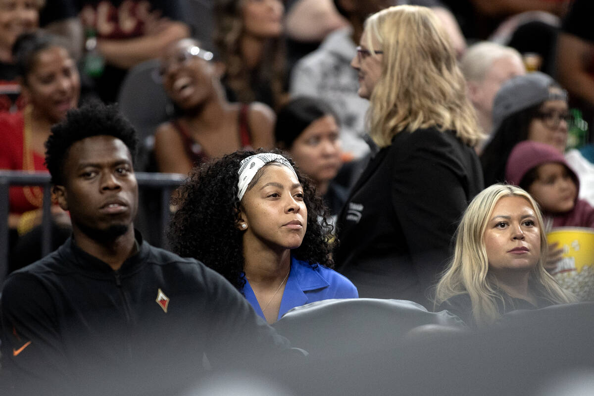 Las Vegas Aces forward Candace Parker, center, who is injured, watches from the sidelines durin ...