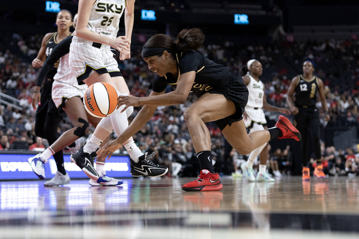 Las Vegas Aces guard Sydney Colson (51) falls to the court while dribbling past Chicago Sky for ...