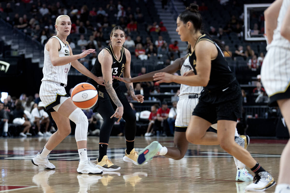 Las Vegas Aces forward Cayla George (13) passes to guard Kelsey Plum, right, while Chicago Sky ...