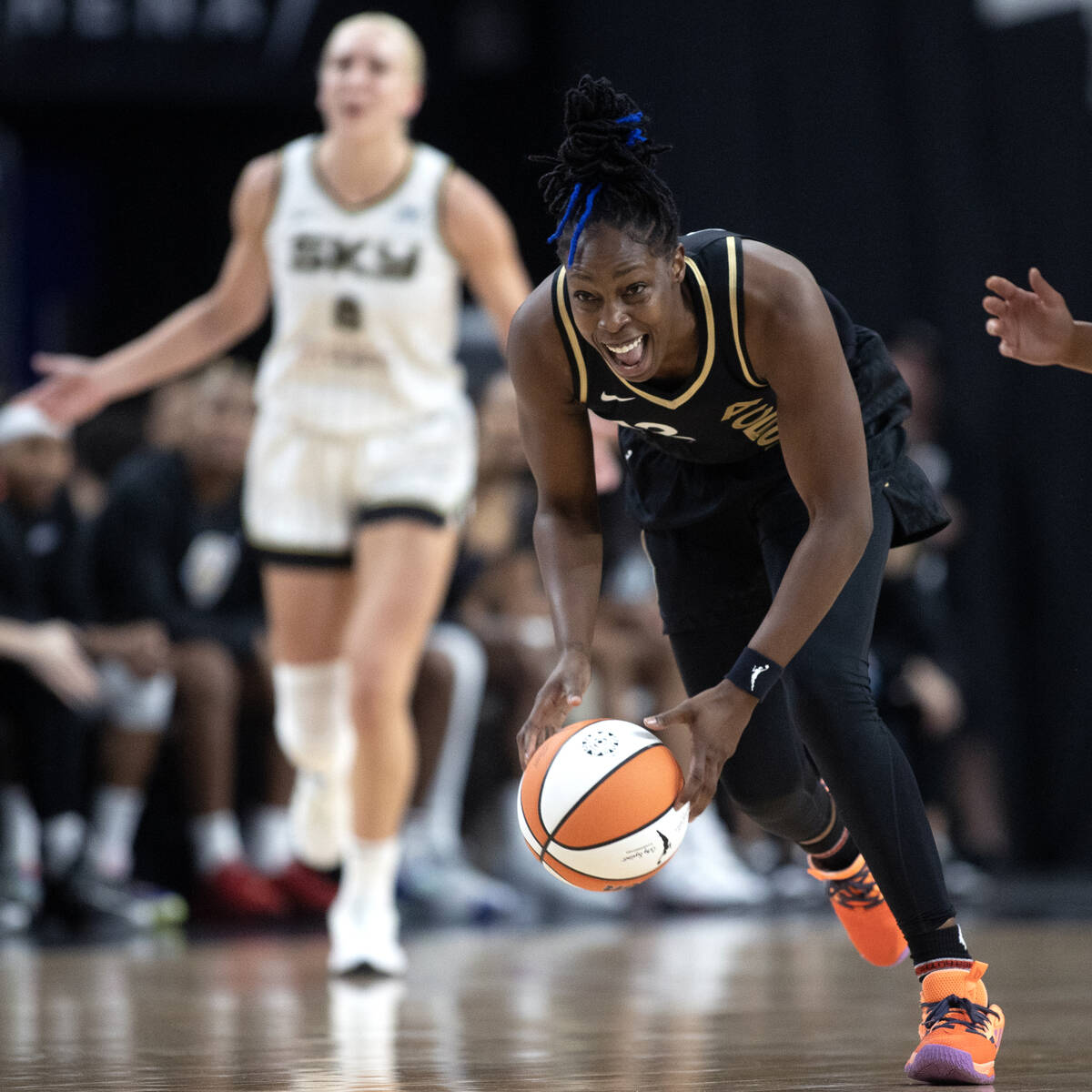 Las Vegas Aces guard Chelsea Gray (12) reacts as she runs up the court with a stolen ball from ...