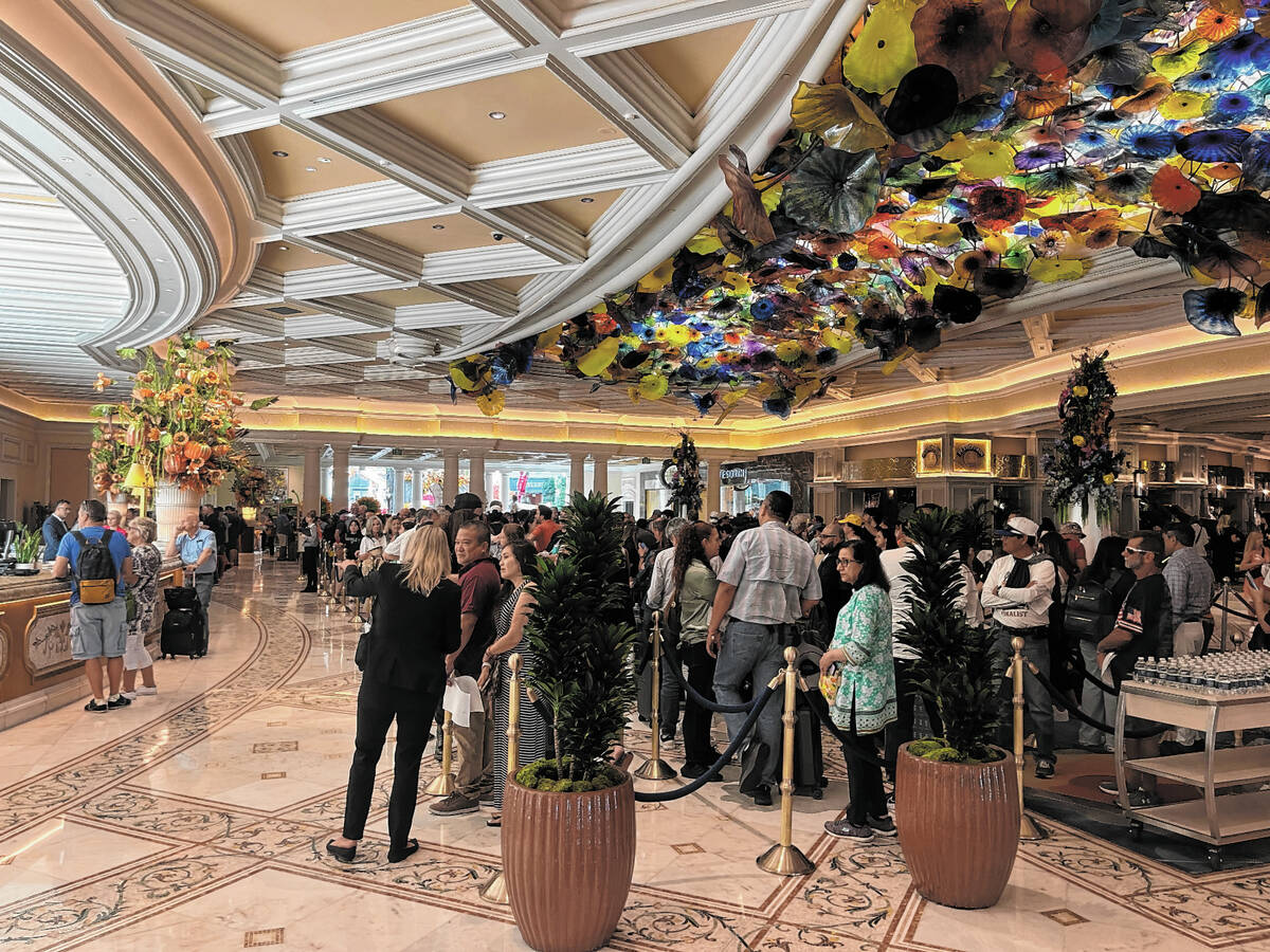 A crowd of people wait to check in with the front desk at the Bellagio on Wednesday Sept. 13, 2 ...