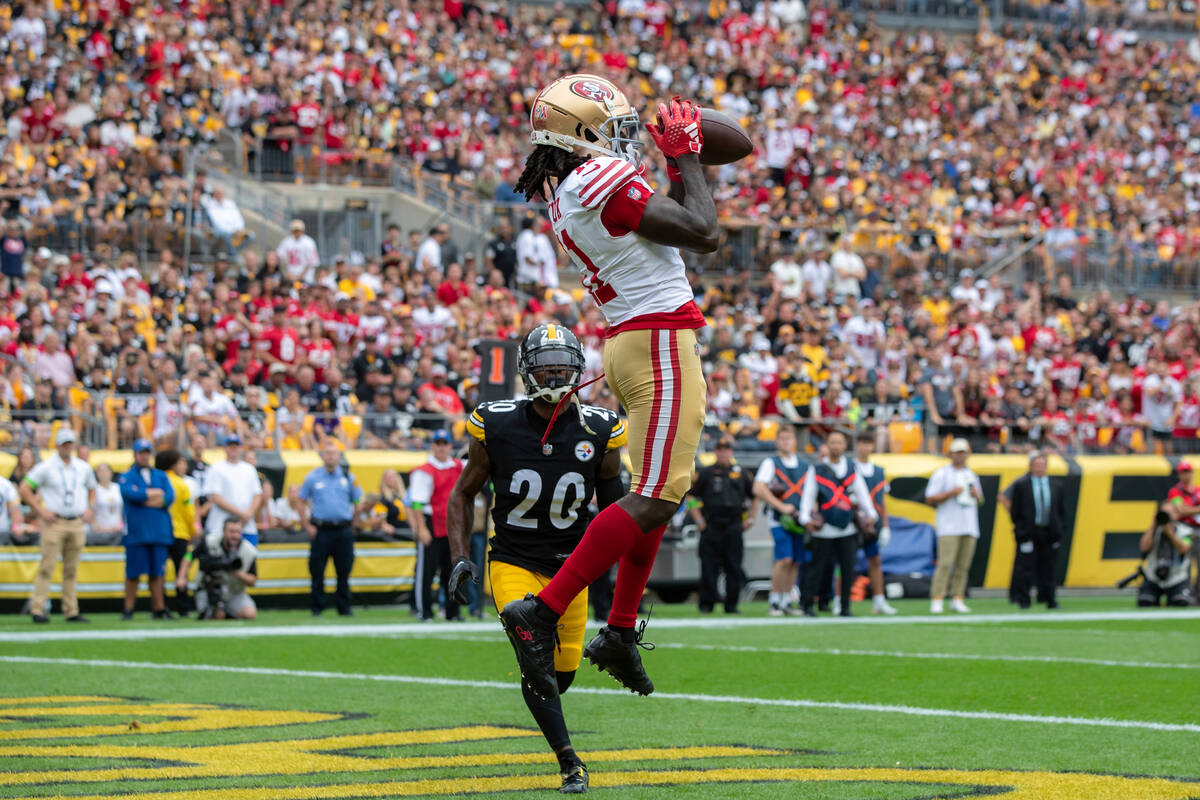 San Francisco 49ers wide receiver Brandon Aiyuk (11) catches a touchdown pass during an NFL foo ...