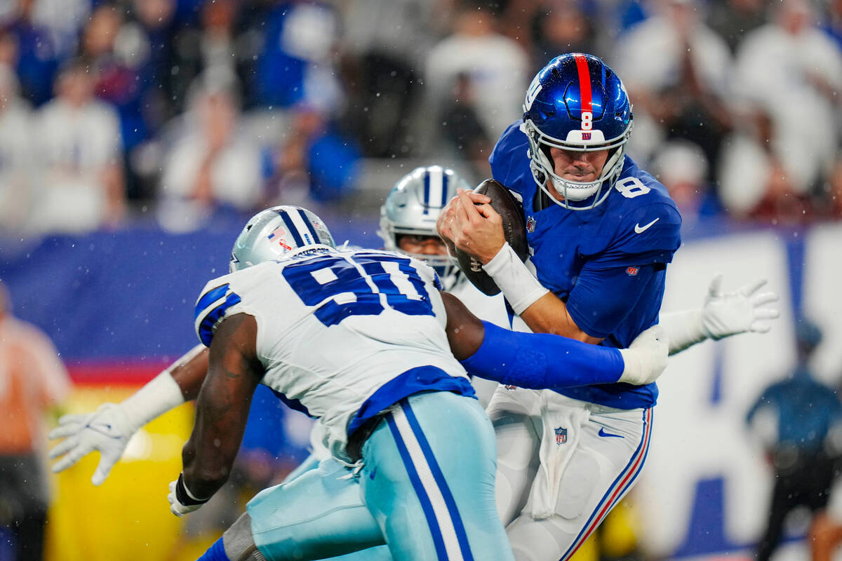 New York Giants quarterback Daniel Jones (8) struggles under pressure form Dallas Cowboys defen ...