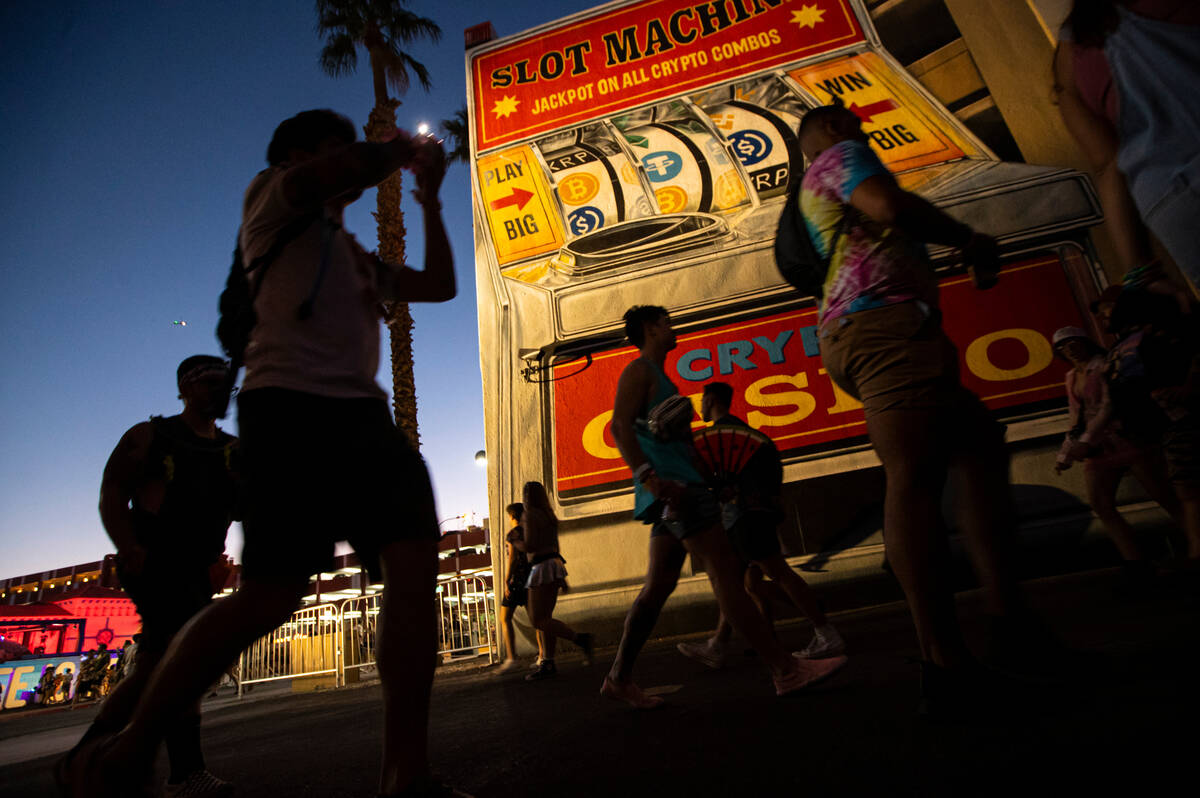 Attendees walk by a mural during the first day of the Life is Beautiful festival on Friday, Sep ...