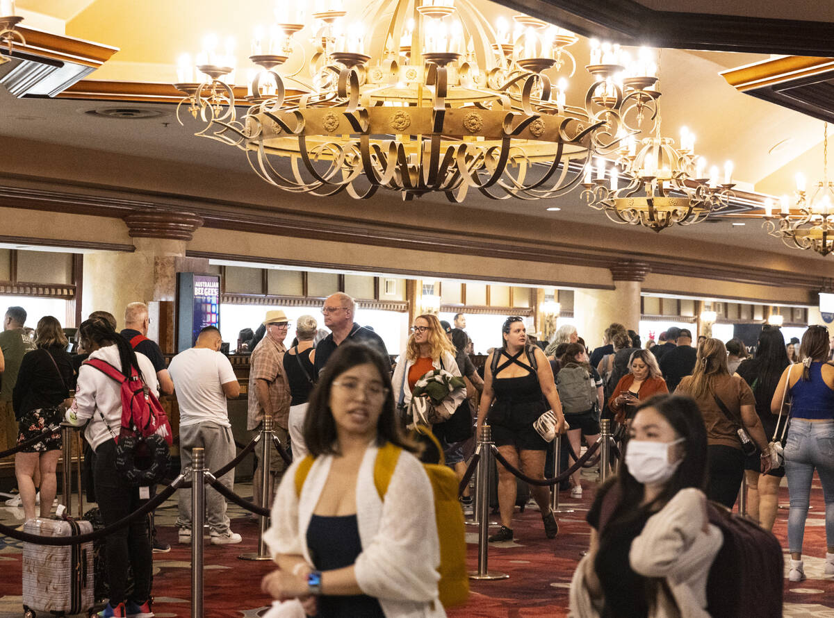 Hotel guests wait in line as they check in at Excalibur hotel- casino, on Thursday, Sept. 14, 2 ...