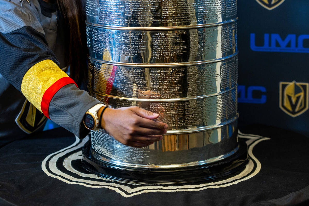 A UMC Hospital worker poses with the Stanley Cup during a visit for employees presented by the ...