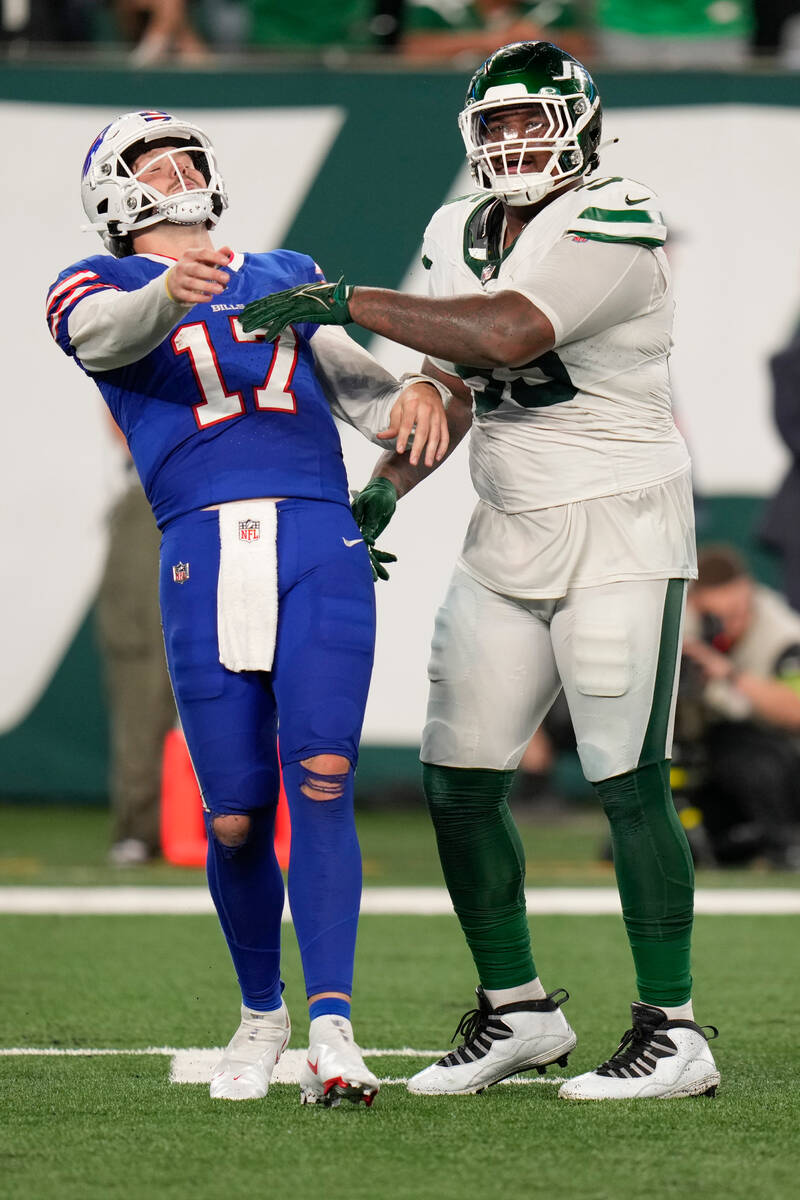 New York Jets Quinnen Williams (95), right, pushes Buffalo Bills quarterback Josh Allen (17) du ...