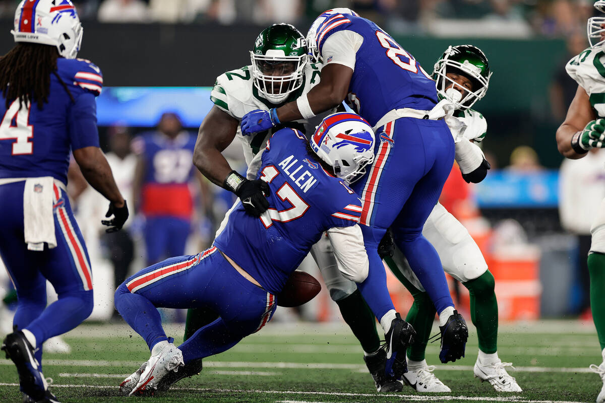 Buffalo Bills quarterback Josh Allen (17) fumbles the ball as he is hit by New York Jets defens ...