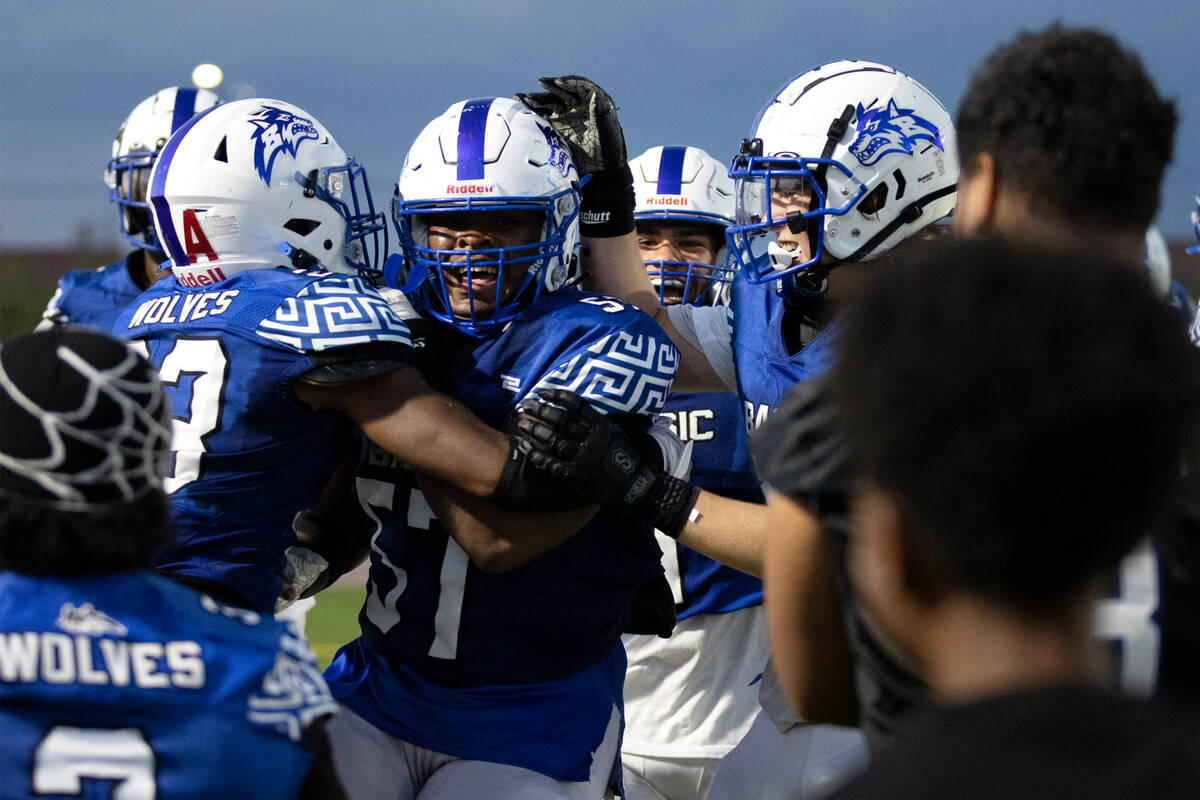 Basic surrounds offensive lineman Antoine Taylor (57) after he scored a touchdown during the fi ...