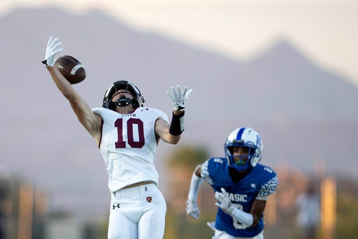 Faith Lutheran quarterback Graham Radke (10) fumbles a catch while Basic wide receiver Demarion ...