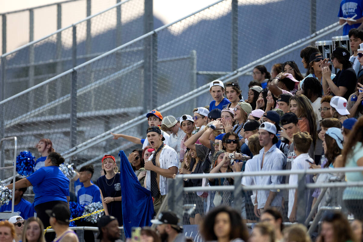 The Basic student section cheers for their team during the first half of a high school football ...