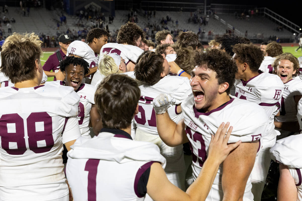 Faith Lutheran celebrates their overtime win over Basic in a high school football game at Basic ...