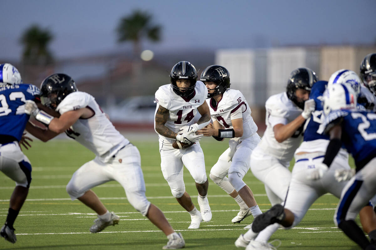 Faith Lutheran running back Cale Breslin (14) looks for an opening to run the ball during the f ...