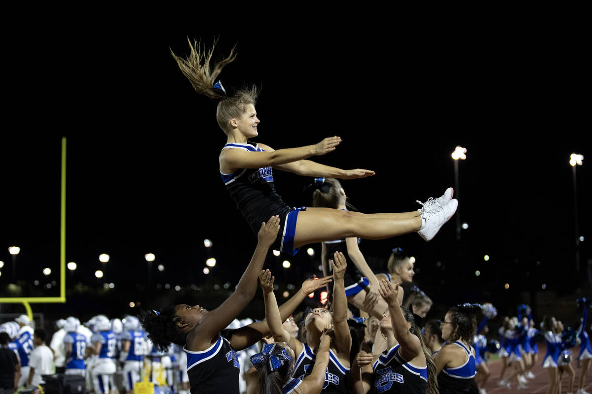 Basic cheerleaders do a stunt during the second half of a high school football game against Fai ...