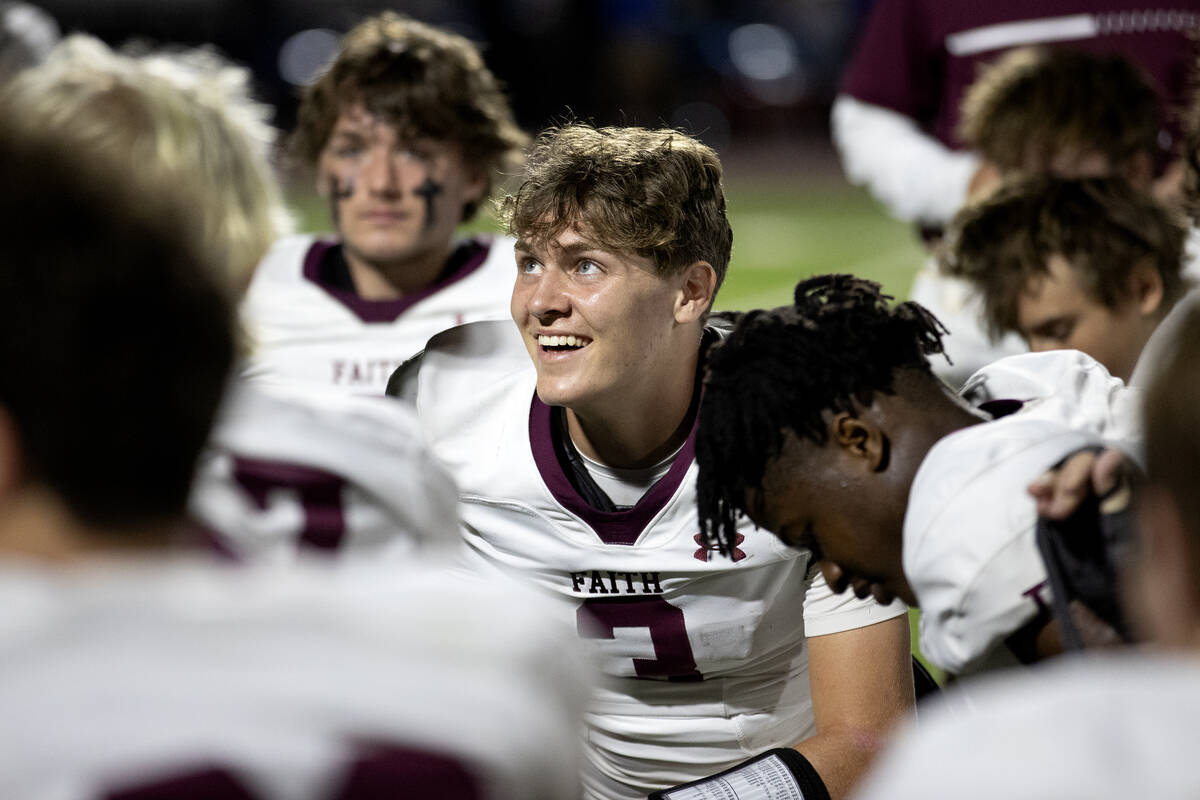 Faith Lutheran quarterback Garyt Odom (3) smiles at his coach’s post-game talk after his ...