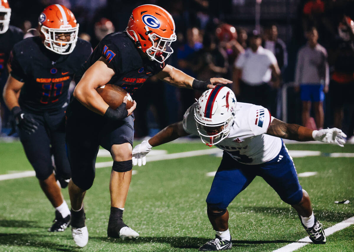 Bishop Gorman offensive linebacker Charles Correa (10) pushes off Liberty running back Isaiah L ...