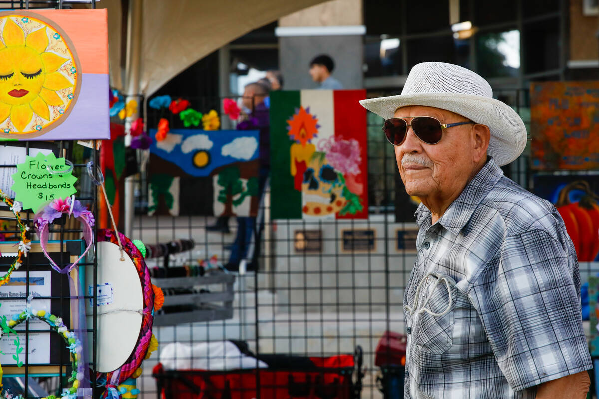 Gustavo Ramos-Bennett in front of his art stand for City of the World at the Hispanic Heritage ...