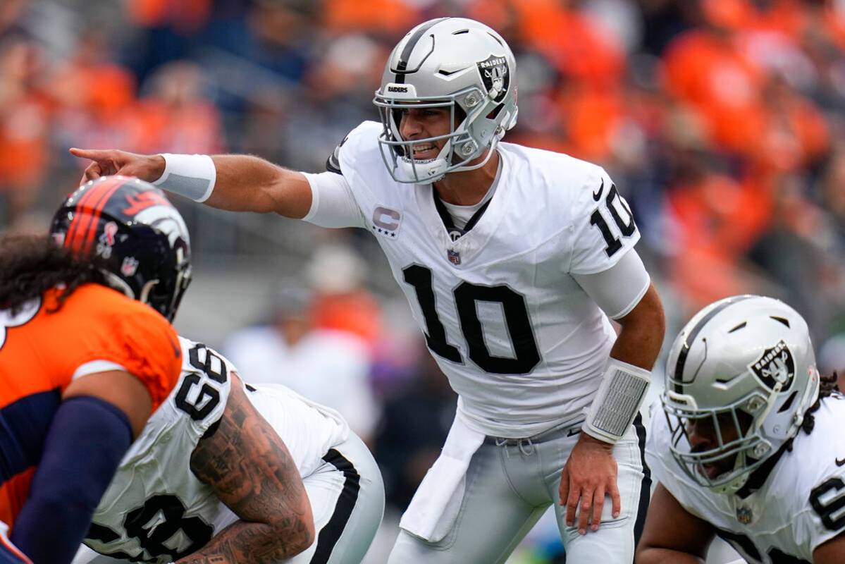 Las Vegas Raiders quarterback Jimmy Garoppolo (10) signals against the Denver Broncos during an ...