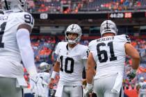 Las Vegas Raiders quarterback Jimmy Garoppolo (10) greets teammates as they come onto the field ...