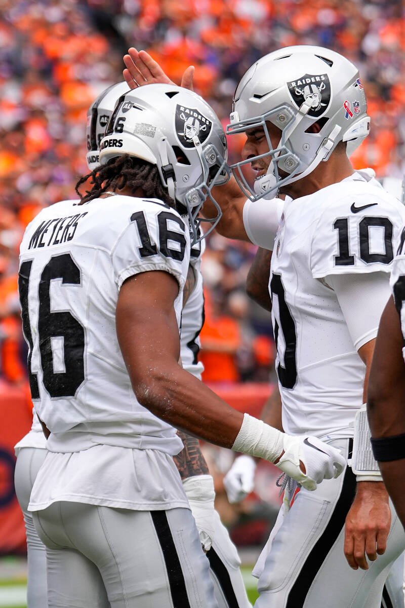 Las Vegas Raiders quarterback Jimmy Garoppolo celebrates a touchdown with wide receiver Jakobi ...