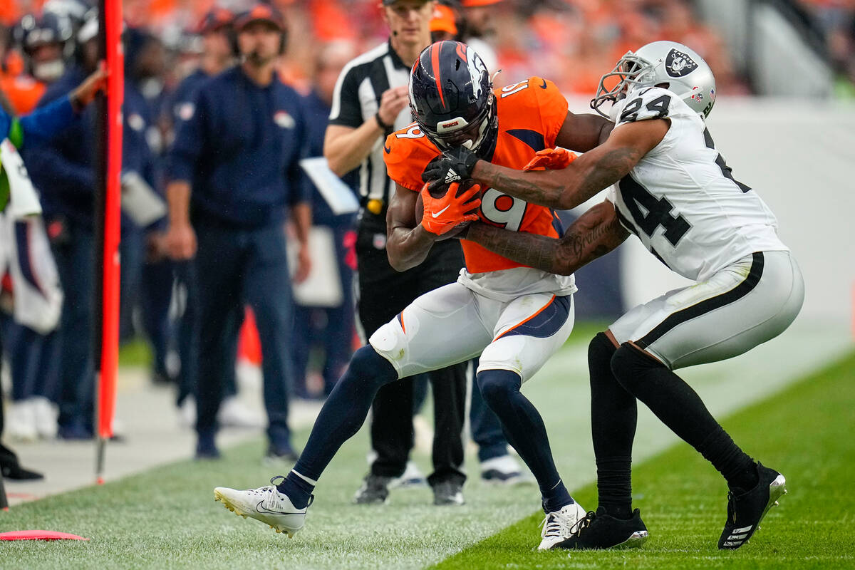 Denver Broncos wide receiver Marvin Mims Jr. (19) is tackled by Las Vegas Raiders cornerback Ma ...