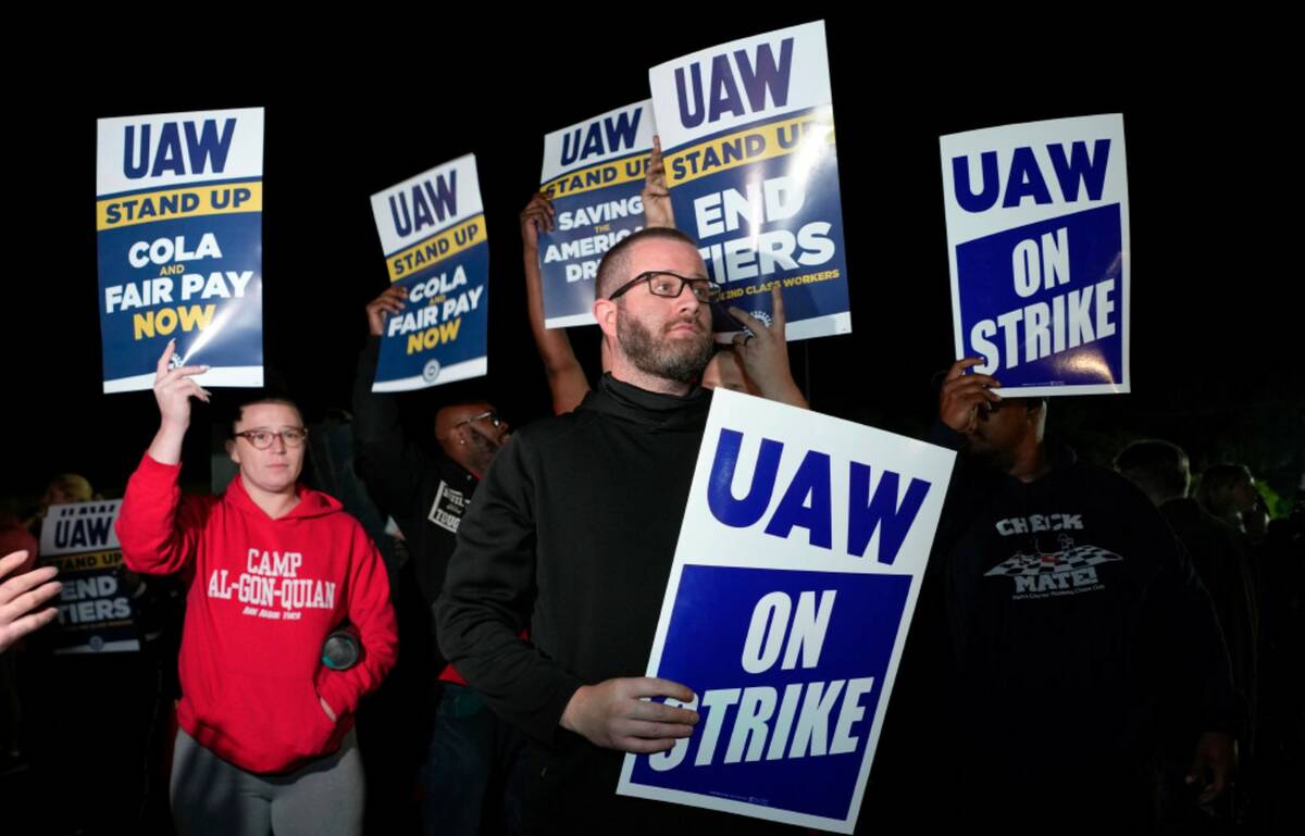 Striking United Auto Workers picket at Ford's Michigan Assembly Plant in Wayne, Mich., Friday, ...