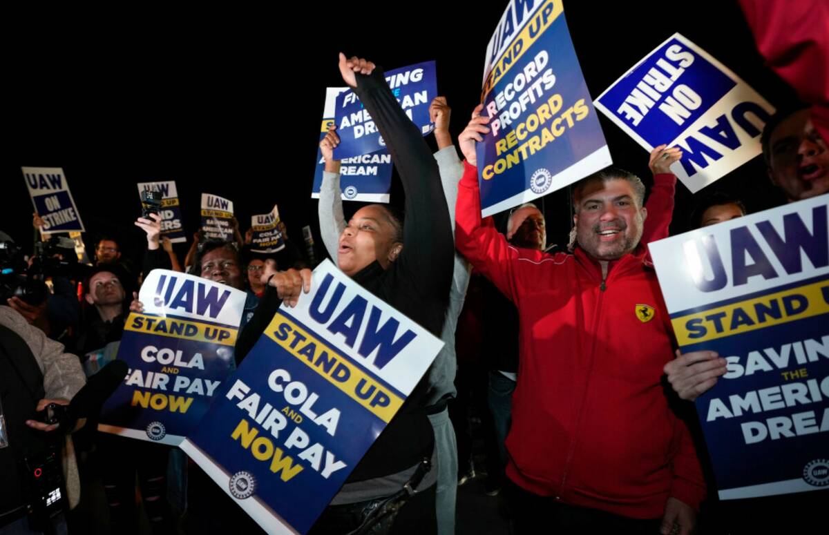 Striking United Auto Workers picket at Ford's Michigan Assembly Plant in Wayne, Mich., Friday, ...