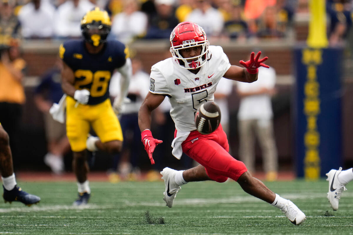 UNLV running back Vincent Davis Jr. (5) runs to recover a fumble against Michigan in the second ...