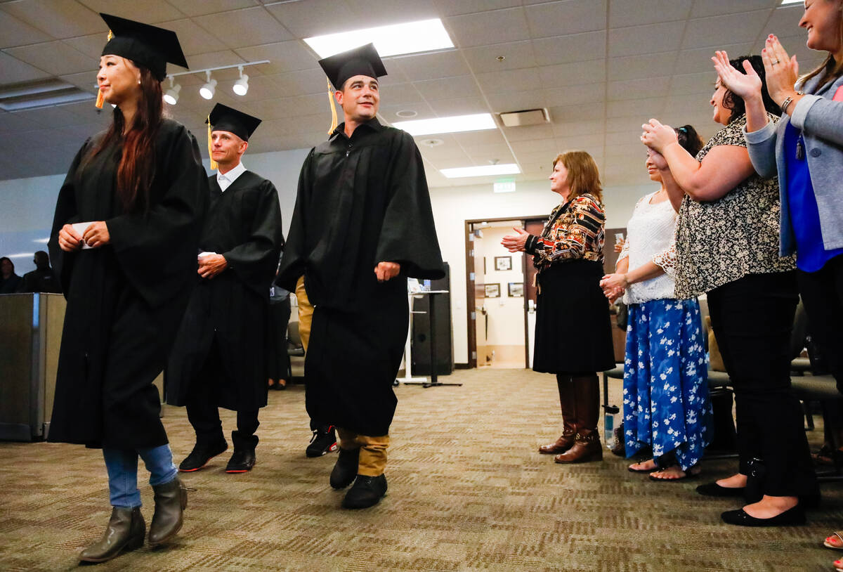 From left, Susan Kim, Michael Sollami and Sean Nesbitt are applauded during their graduation ce ...