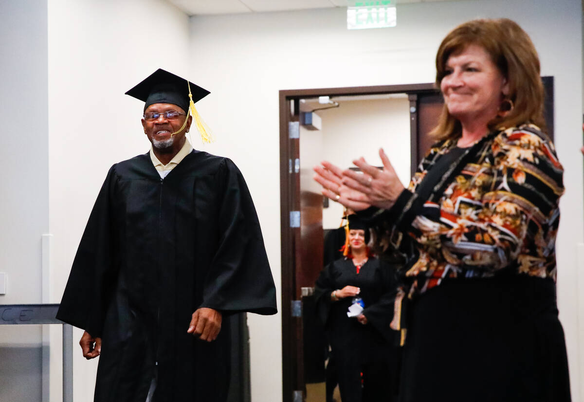 Amy Swogger applauds Sherwood George during a graduation ceremony for those who completed the L ...