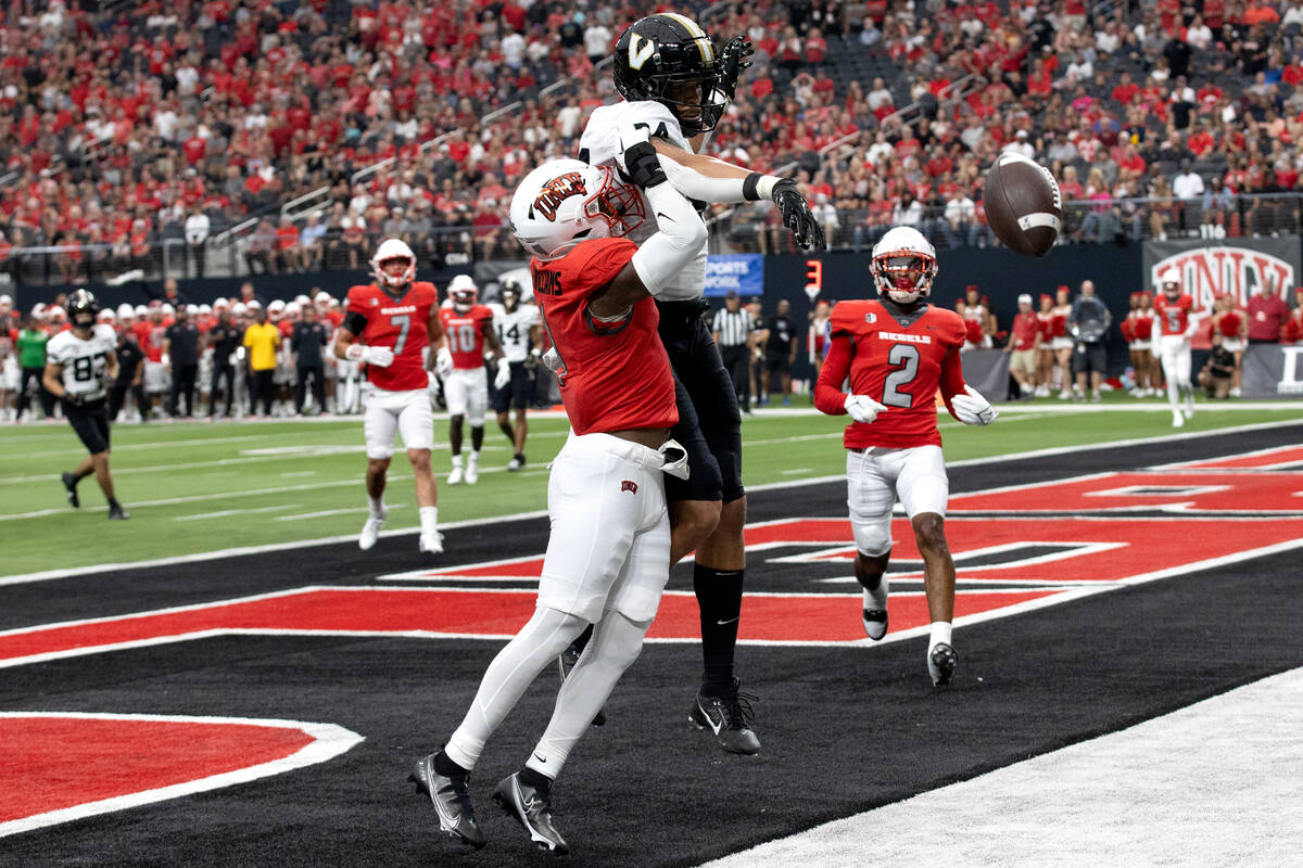 UNLV defensive back Jerrae Williams (1) stops a touchdown catch by Vanderbilt tight end Justin ...