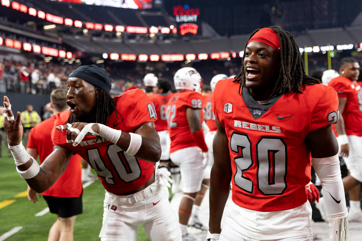 UNLV defensive back Daego Albert (40) and defensive back Trenton Holloway (20) celebrate their ...