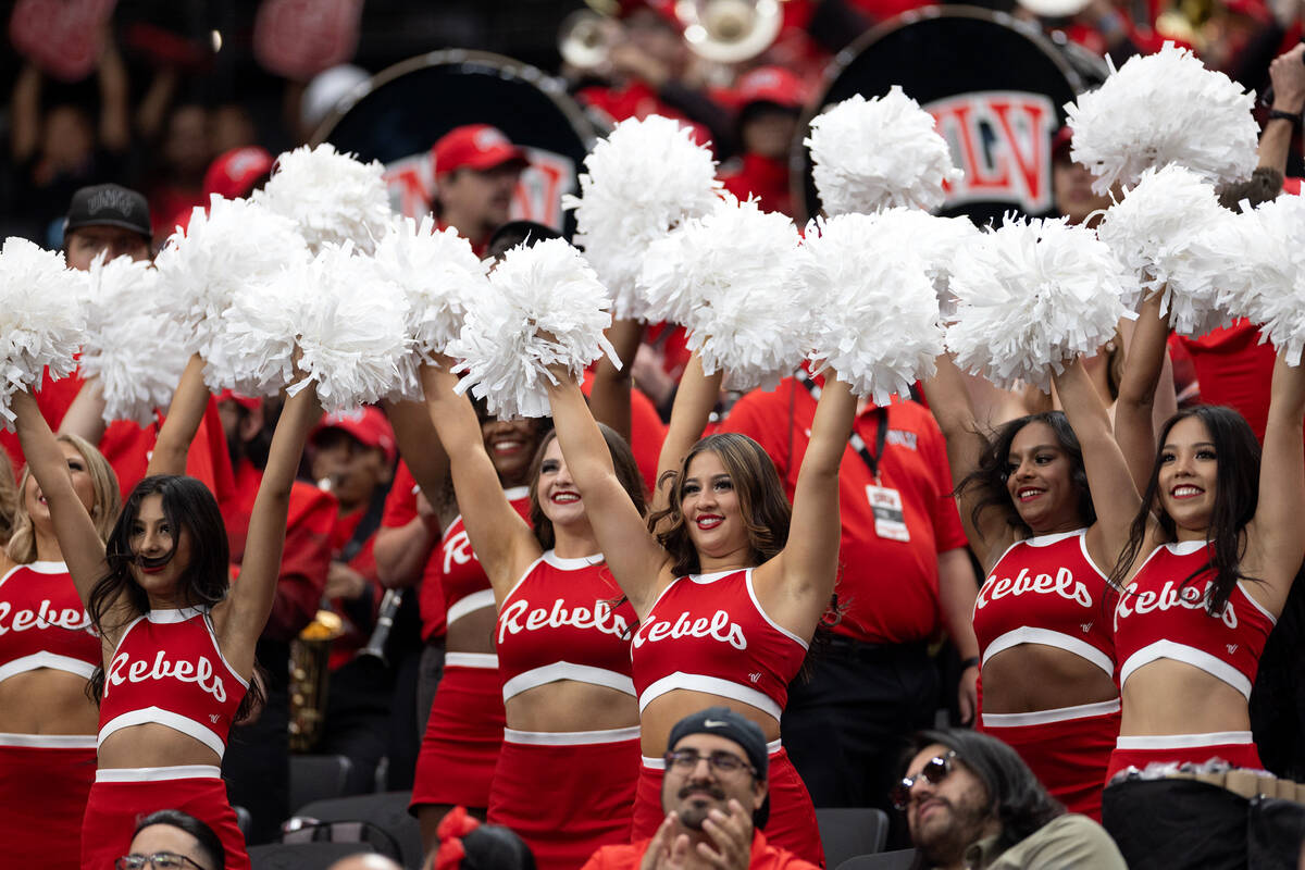 UNLV cheerleaders pump up the crowd during the first half of an NCAA college football game agai ...
