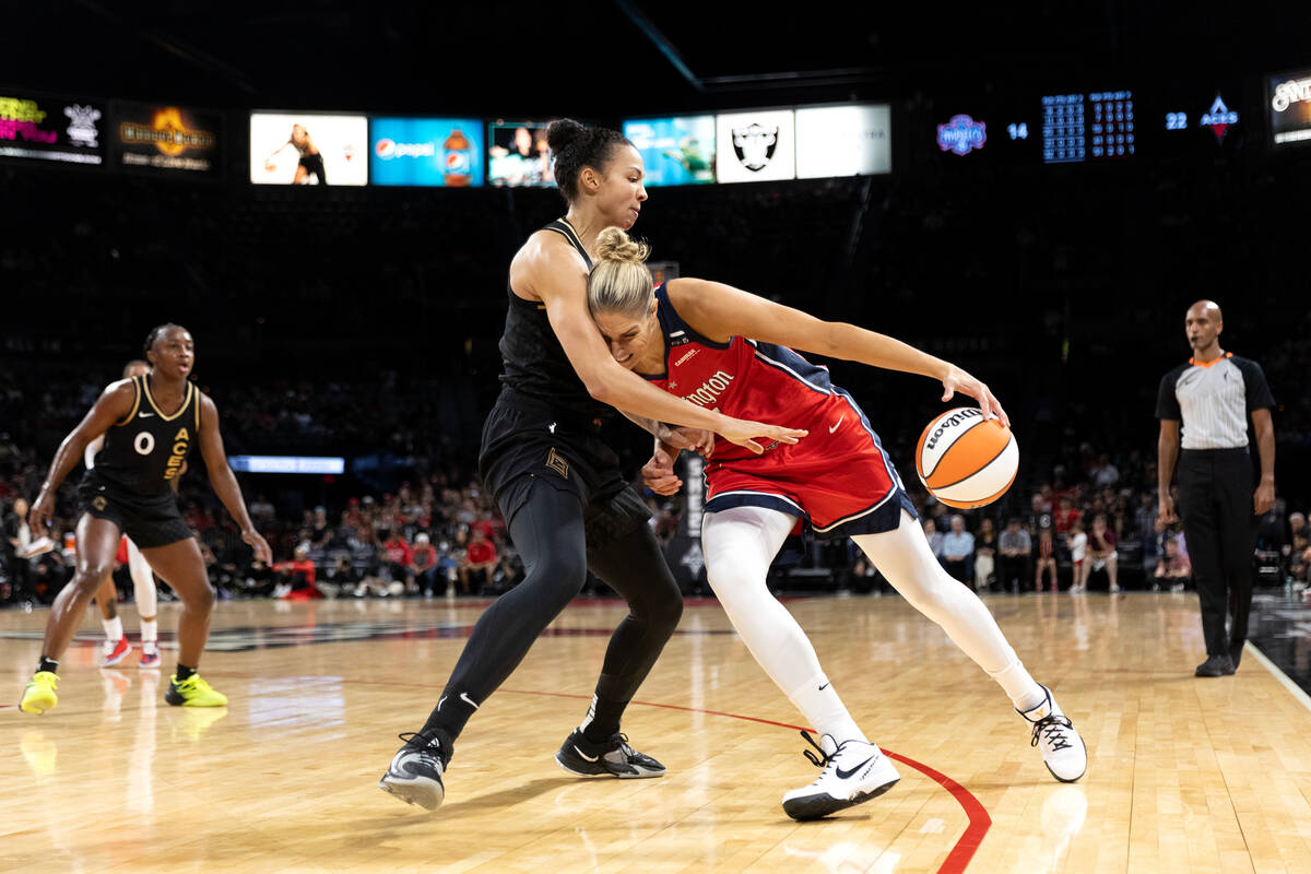 Washington Mystics forward Elena Delle Donne, left, powers around Las Vegas Aces center Kiah St ...