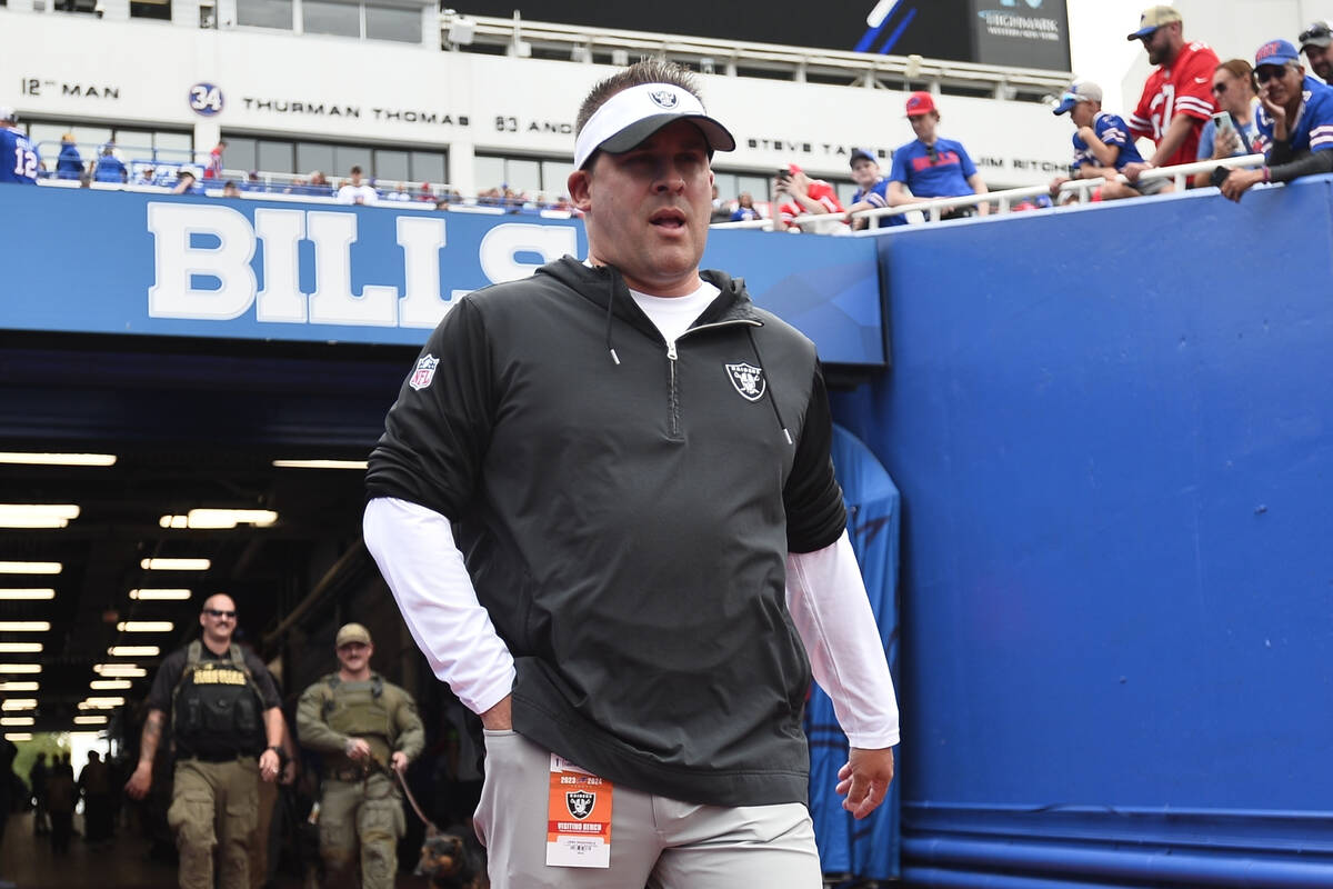 Las Vegas Raiders' head coach Josh McDaniels walks toward the field before an NFL football game ...