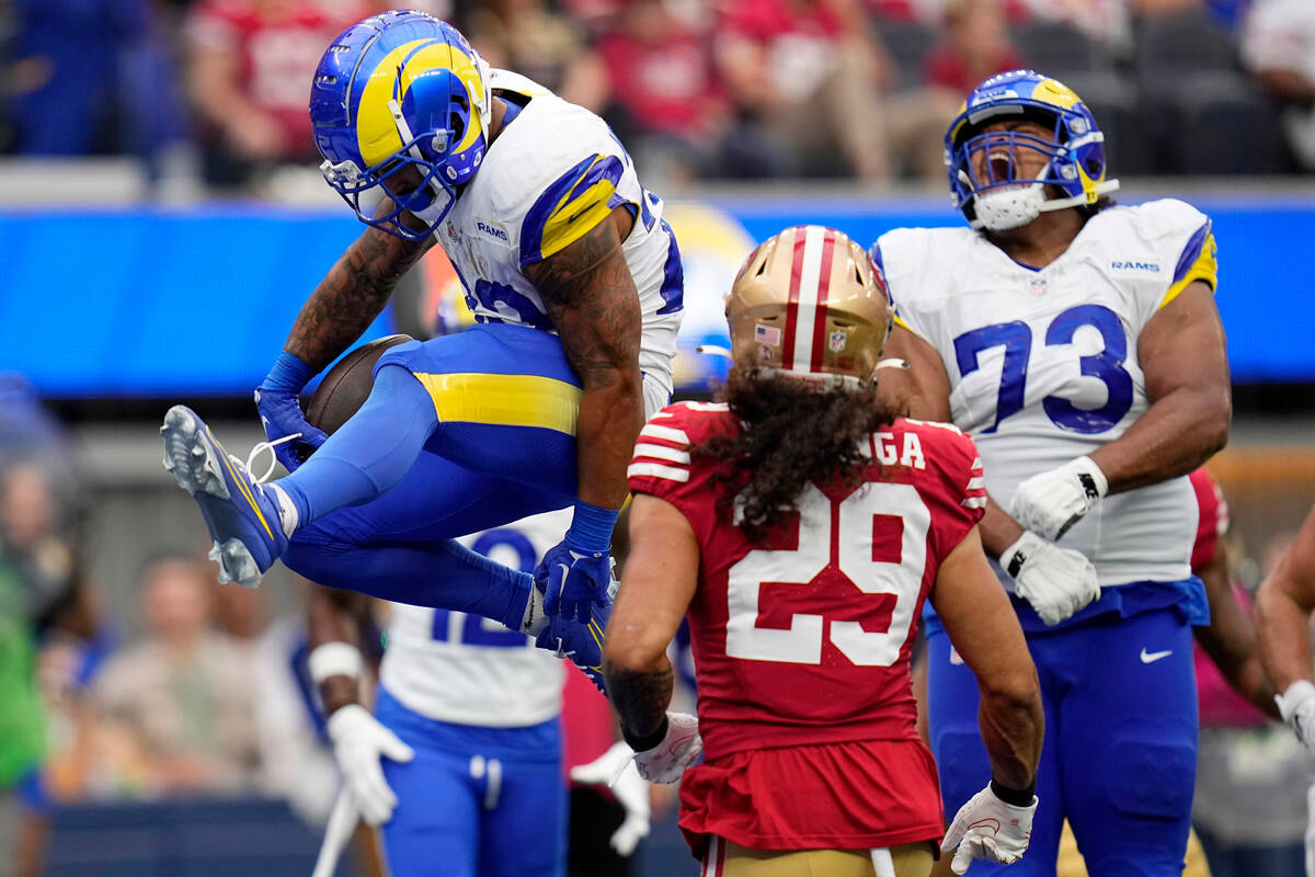 Los Angeles Rams running back Kyren Williams, left, scores a touchdown as guard Steve Avila, ri ...