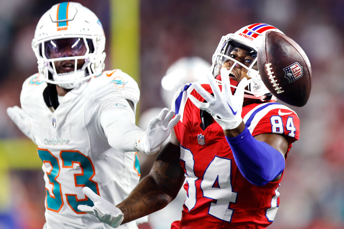 Miami Dolphins cornerback Eli Apple (33) pressures New England Patriots wide receiver Kendrick ...