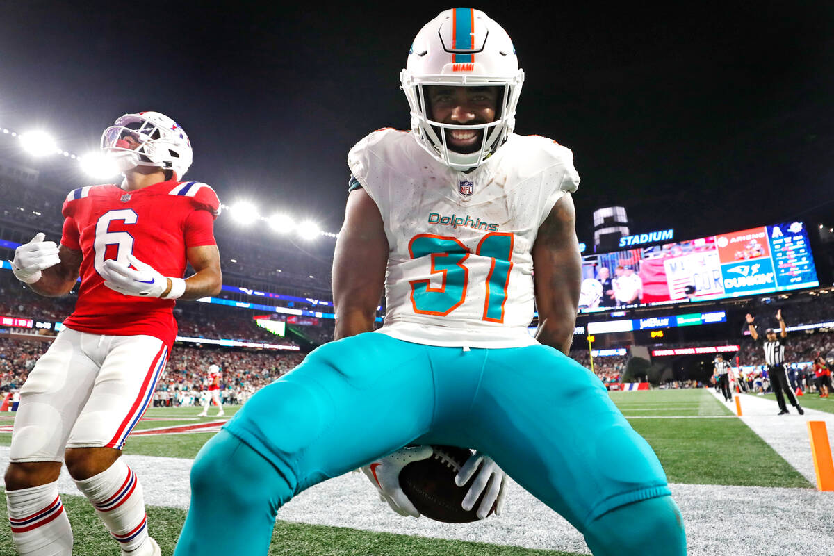 Miami Dolphins running back Raheem Mostert (31) celebrates after his touchdown against the New ...