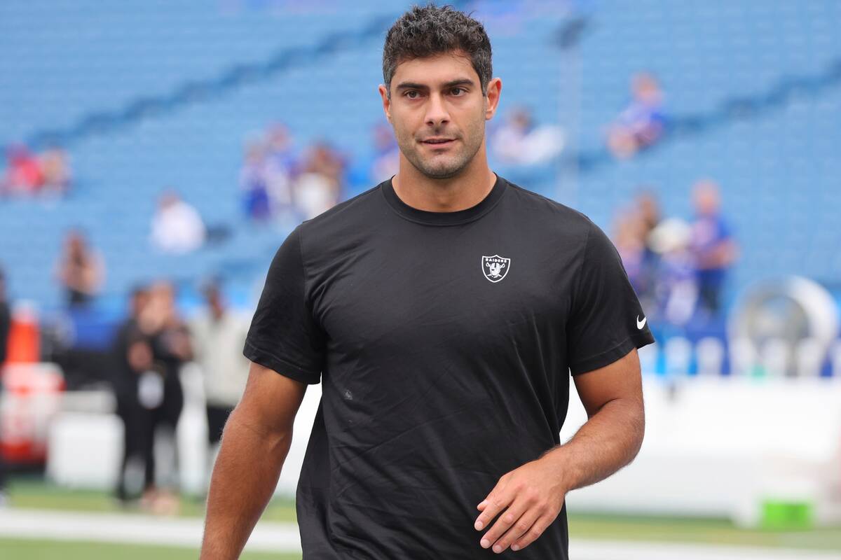 Las Vegas Raiders quarterback Jimmy Garoppolo warms up before an NFL football game against the ...
