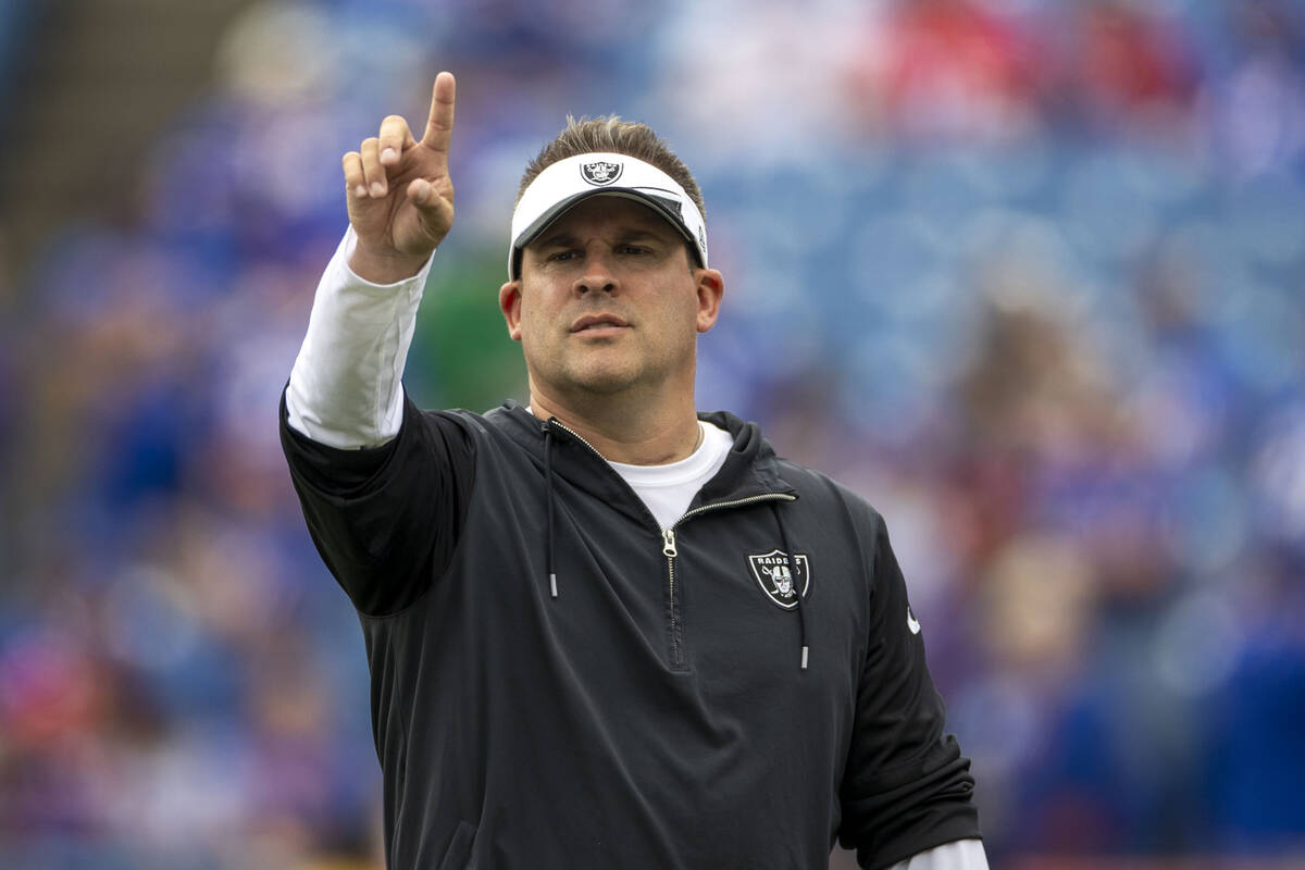Raiders head coach Josh McDaniels points while on the field before an NFL game against the Buff ...
