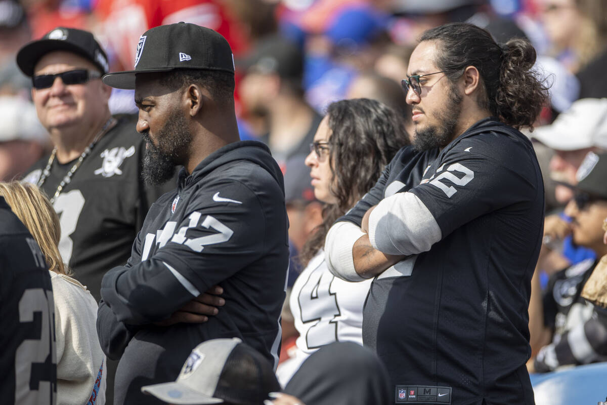 Raiders fans look on as the team falls behind against the Buffalo Bills during the second half ...