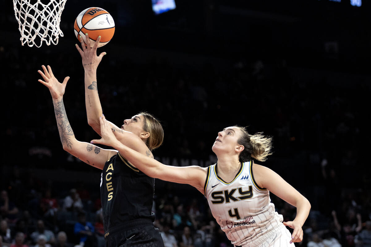 Las Vegas Aces forward Cayla George (13) is fouled by Chicago Sky guard Marina Mabrey (4) durin ...