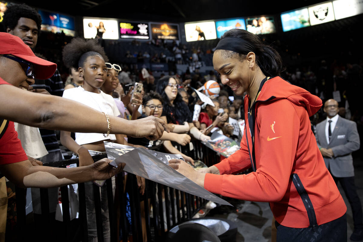 Las Vegas Aces forward A'ja Wilson signs autographs for fans after winning Game 2 in a first-ro ...