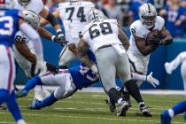 Raiders running back Josh Jacobs (8) tries to get past the line of scrimmage as Buffalo Bills l ...