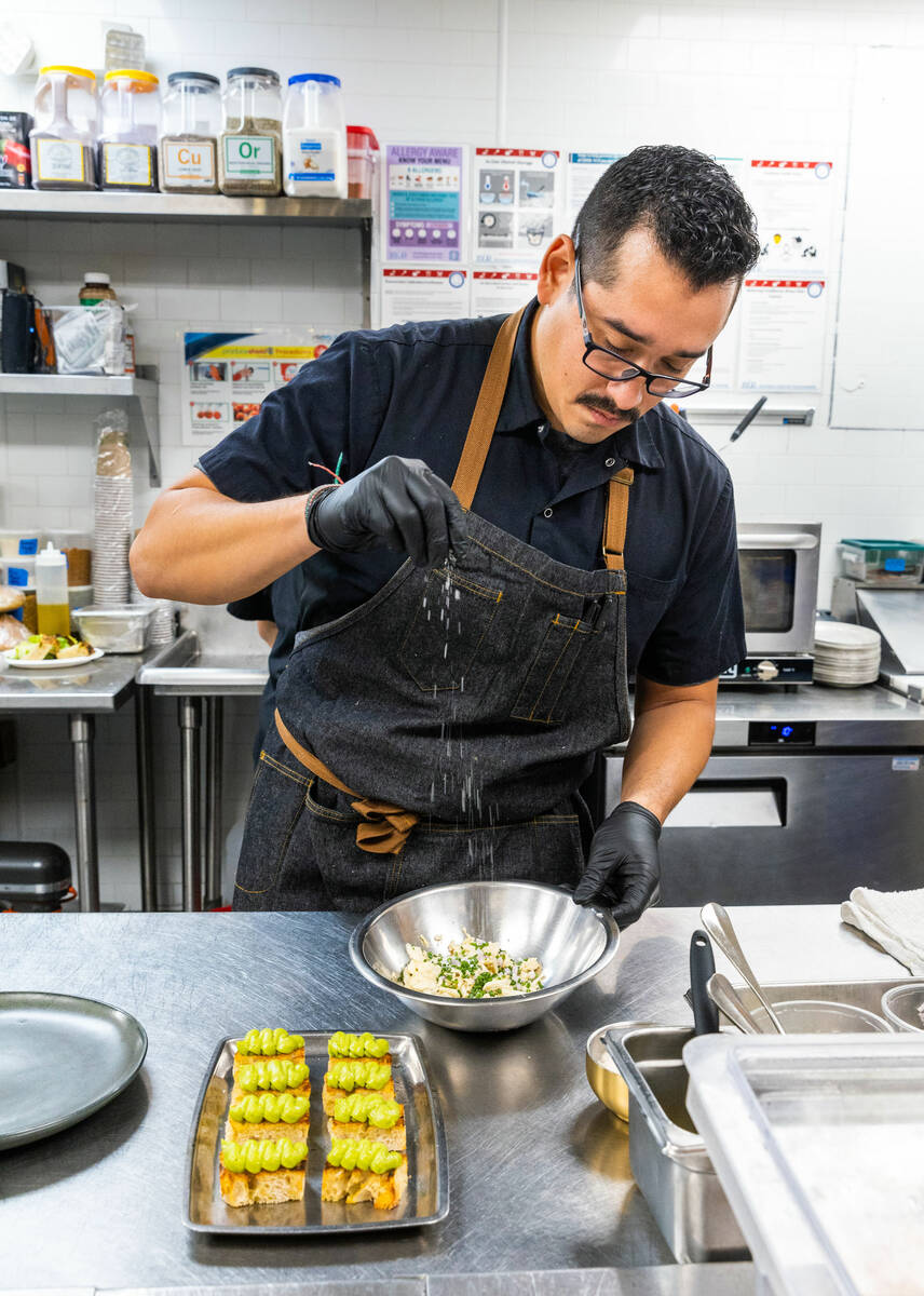 Main St. Provisions executive chef Adrian Garcia constructs miniature avocado sourdough toasts ...