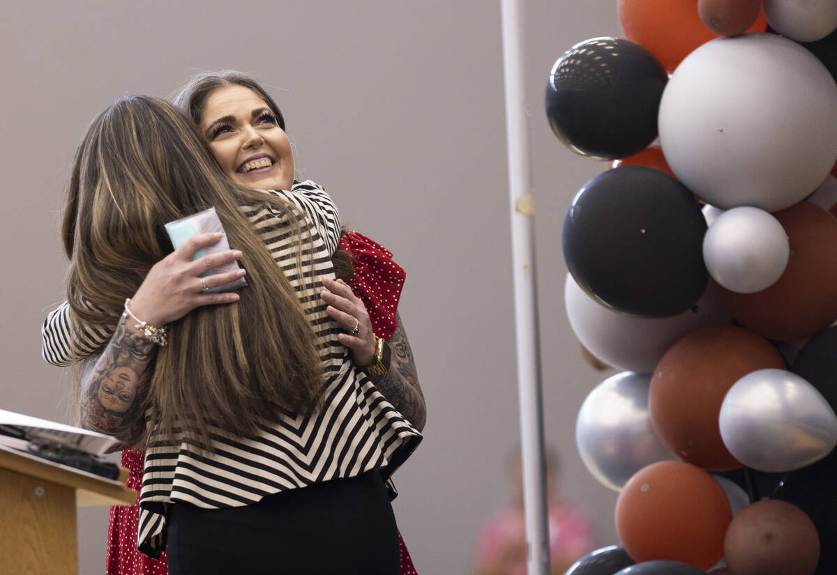 Laura Penrod, facing, an english teacher at Southwest Career and Technical Academy, hugs princi ...