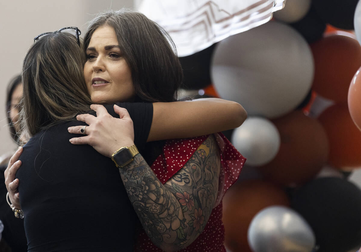 Laura Penrod, right, an english teacher at Southwest Career and Technical Academy, hugs a stude ...