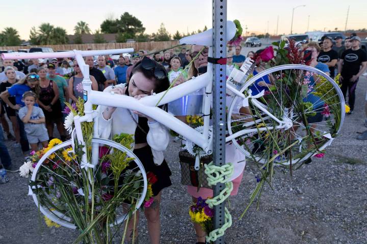 Taylor Probst, left, and Crystal Probst, right, daughter and wife of Andreas Probst, sign a mem ...